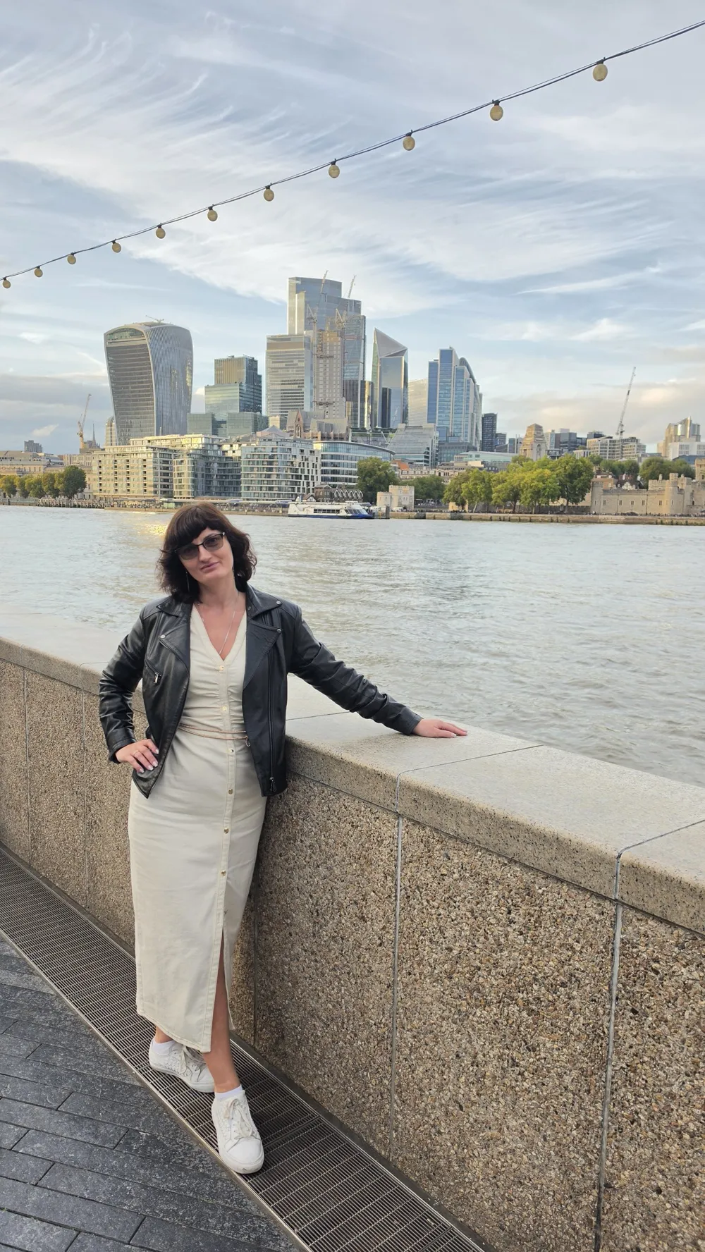 Larysa Brovchuk by the Thames, with the City of London behind